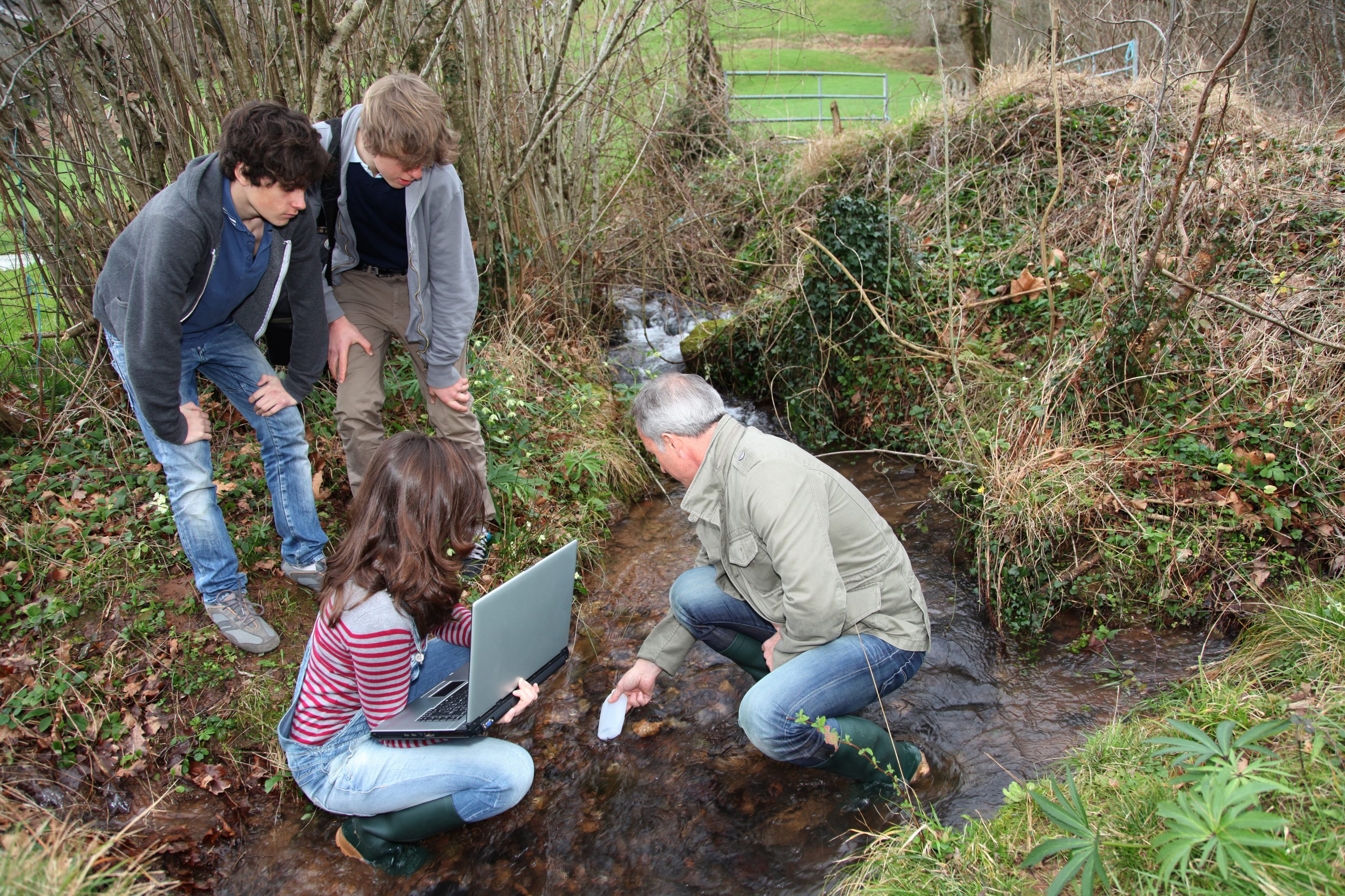 A group of people taking soil samples.